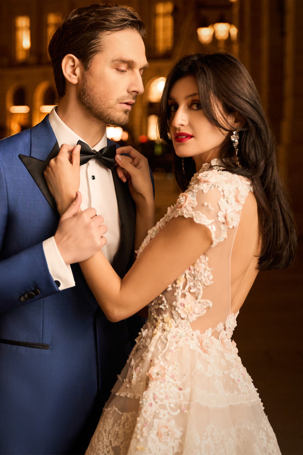 Consiglieri: blue tuxedo with black lapels beside a bridal gown
