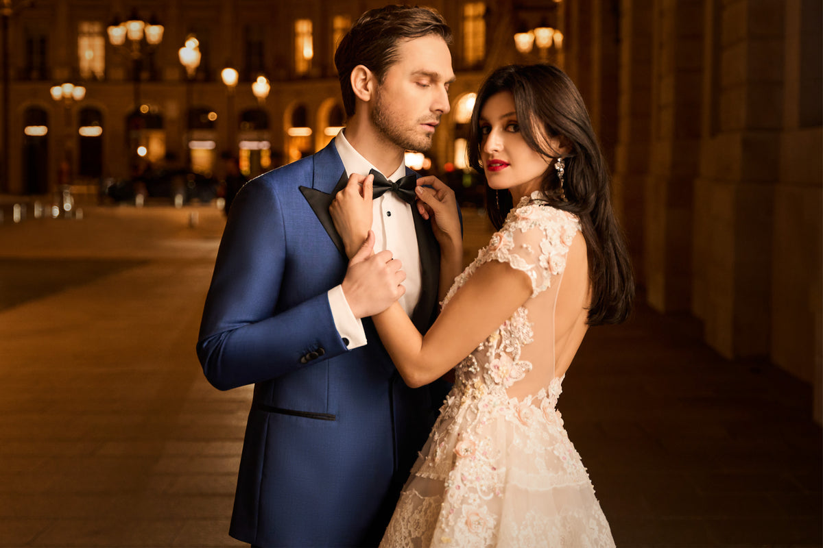 Consiglieri: blue tuxedo with black lapels beside a bridal gown