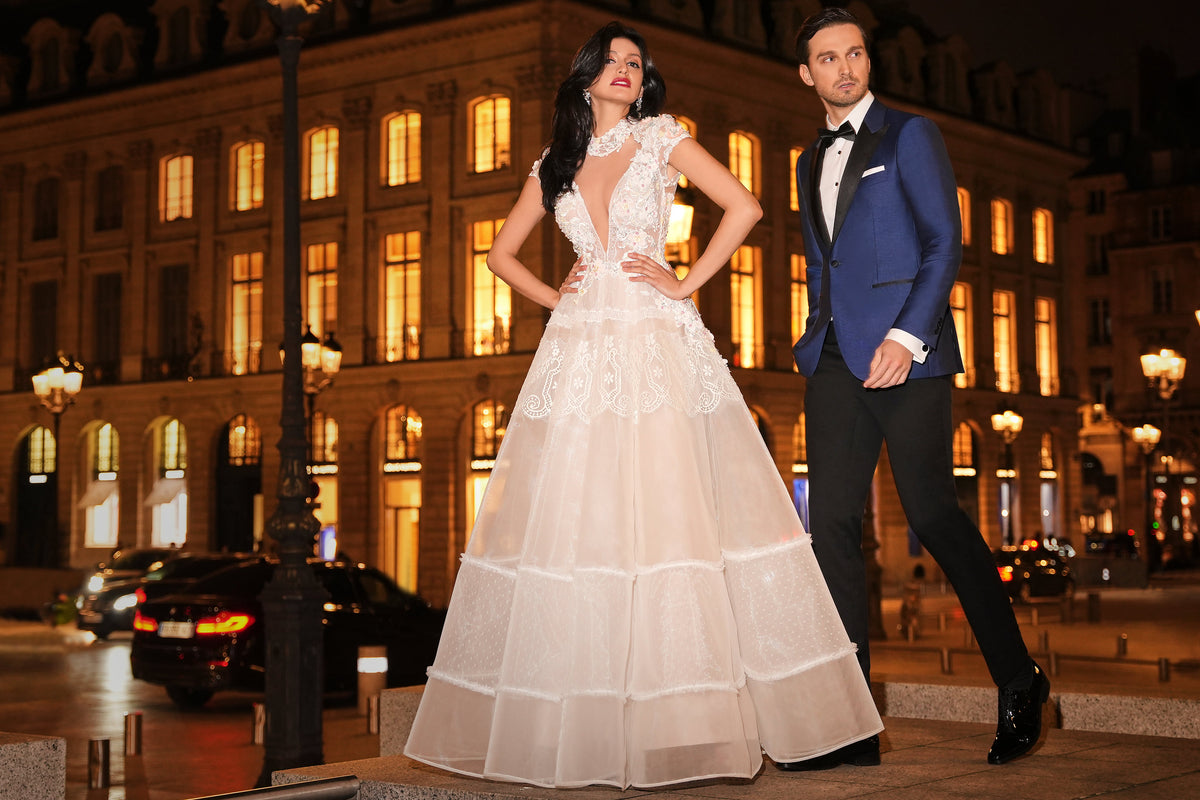 Consiglieri: blue tuxedo with black lapels beside a bridal gown