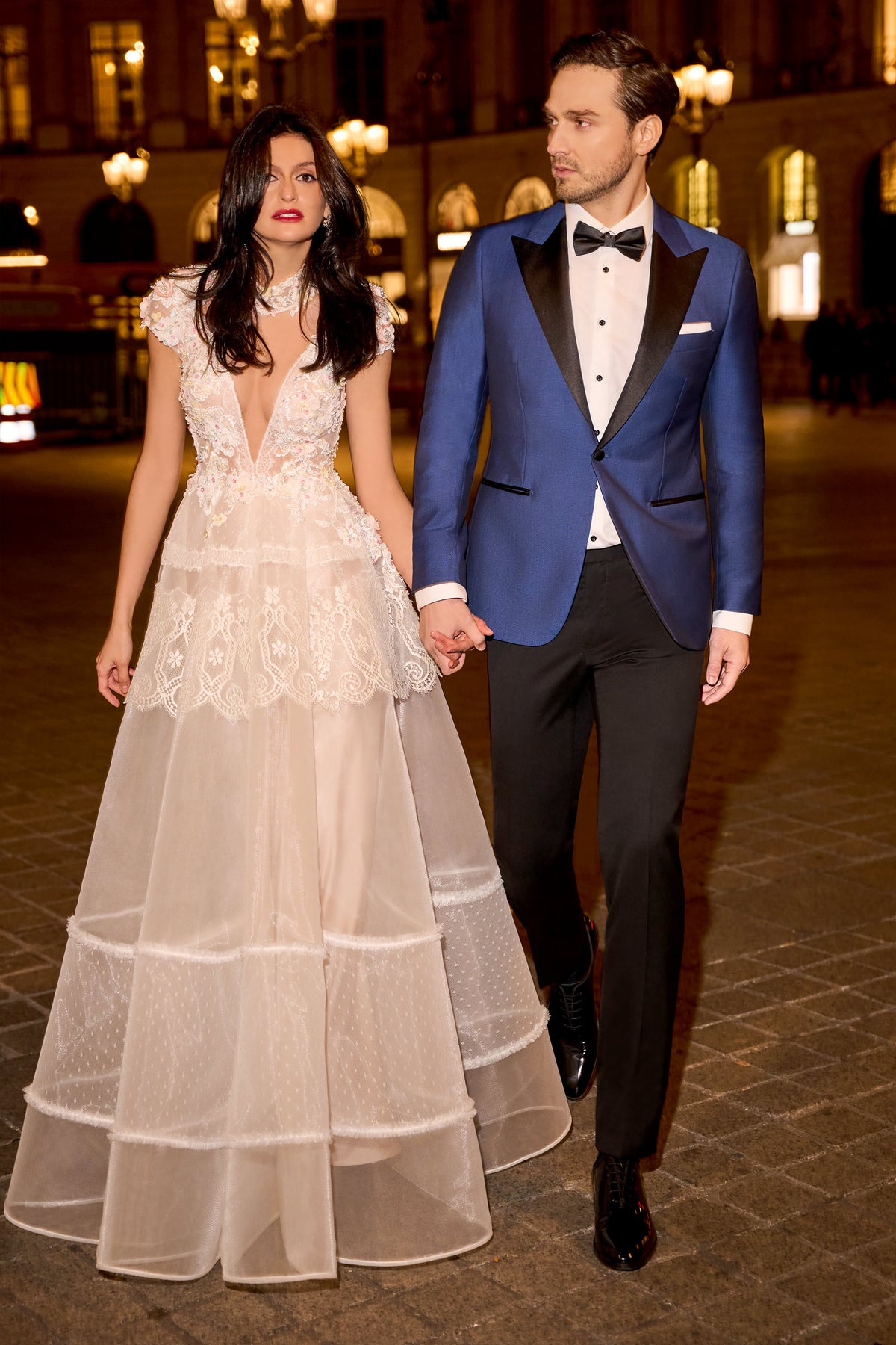 Consiglieri: blue tuxedo with black lapels beside a bridal gown