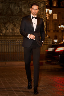 Consiglieri: black tuxedo with contrasting lapels and a bow tie in an evening setting