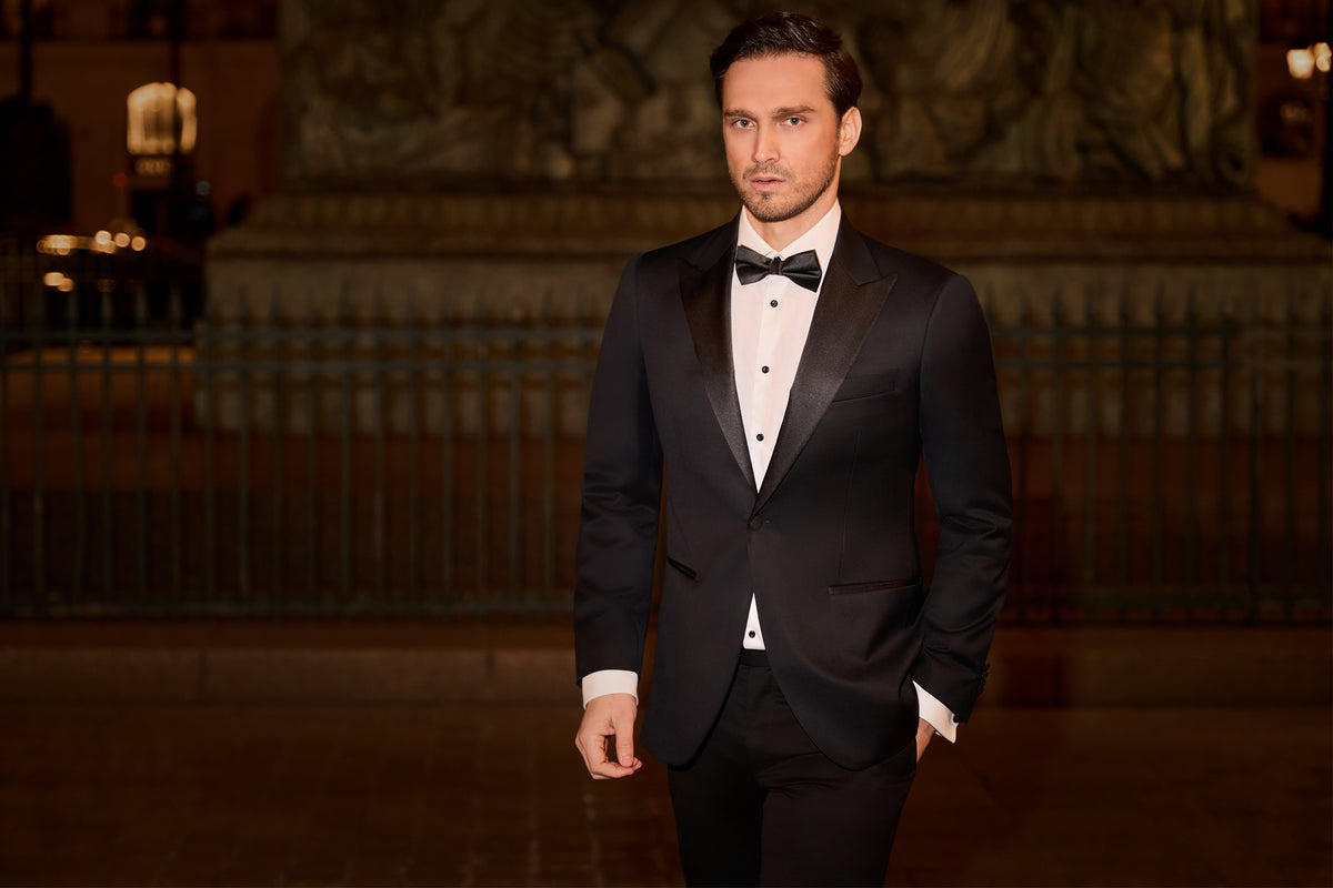 Consiglieri: black tuxedo with contrasting lapels and a bow tie in an evening setting