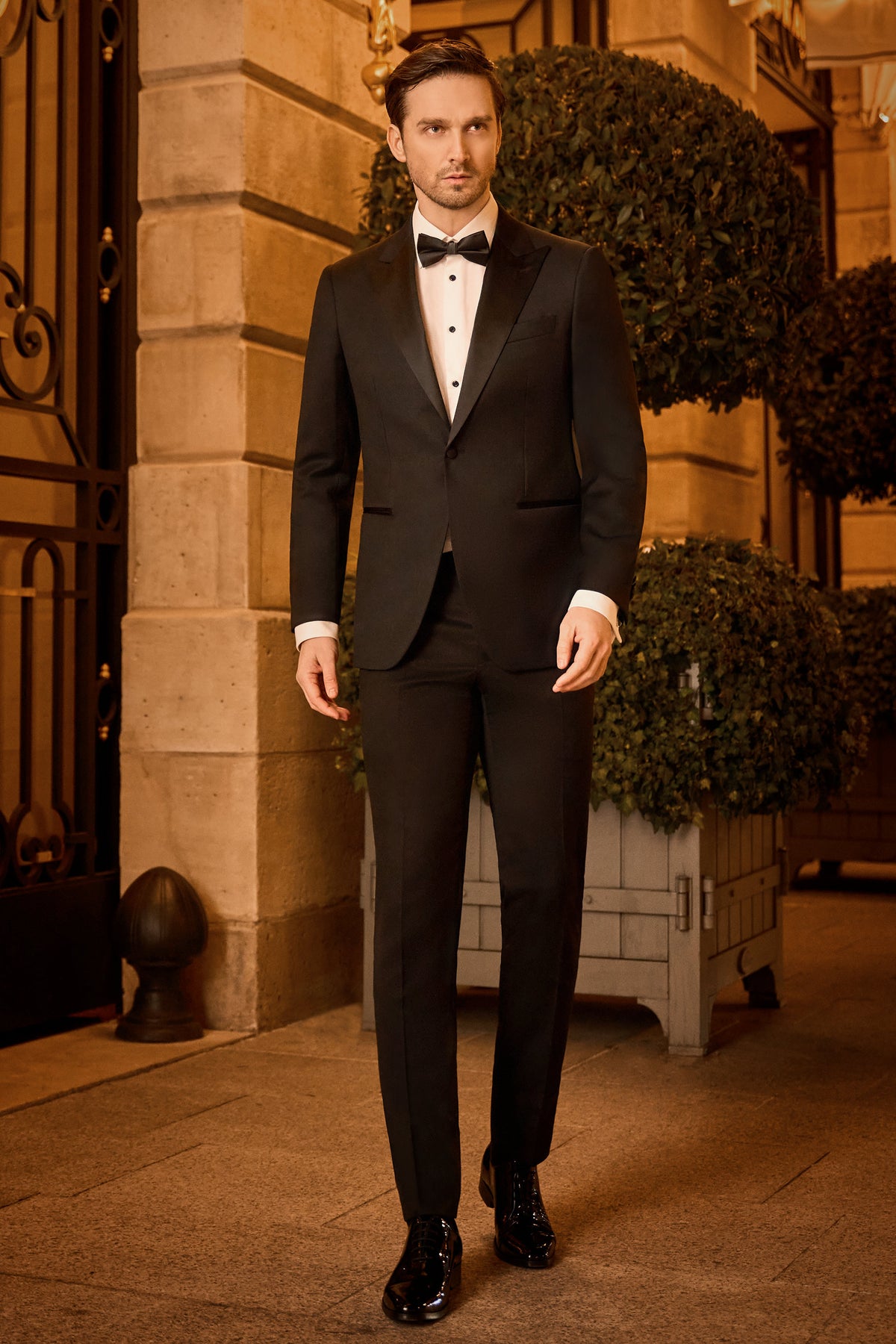 Consiglieri: black tuxedo with contrasting lapels and a bow tie in an evening setting