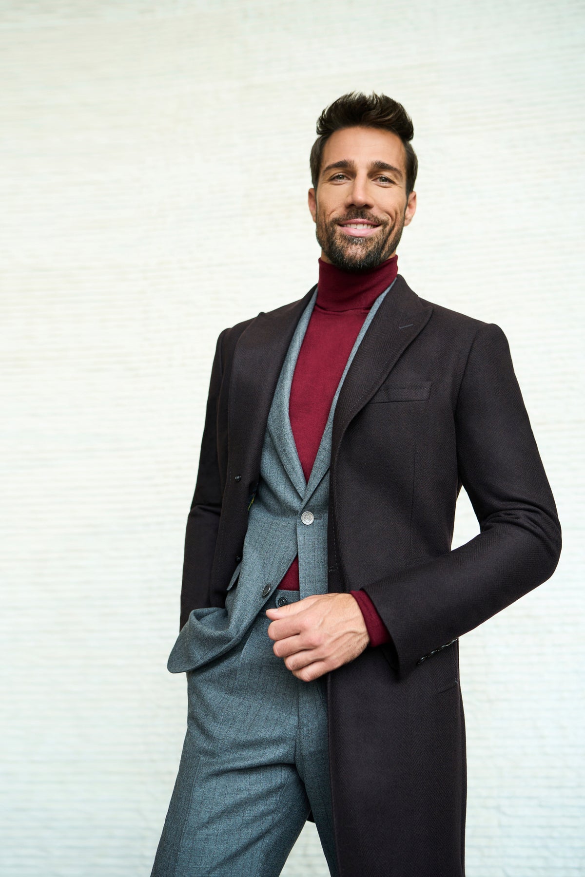 Consiglieri Meribel: deep brown overcoat with a grey suit and burgundy roll-neck