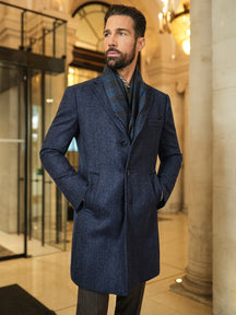 Consiglieri Zermatt: navy textured overcoat with a checked scarf