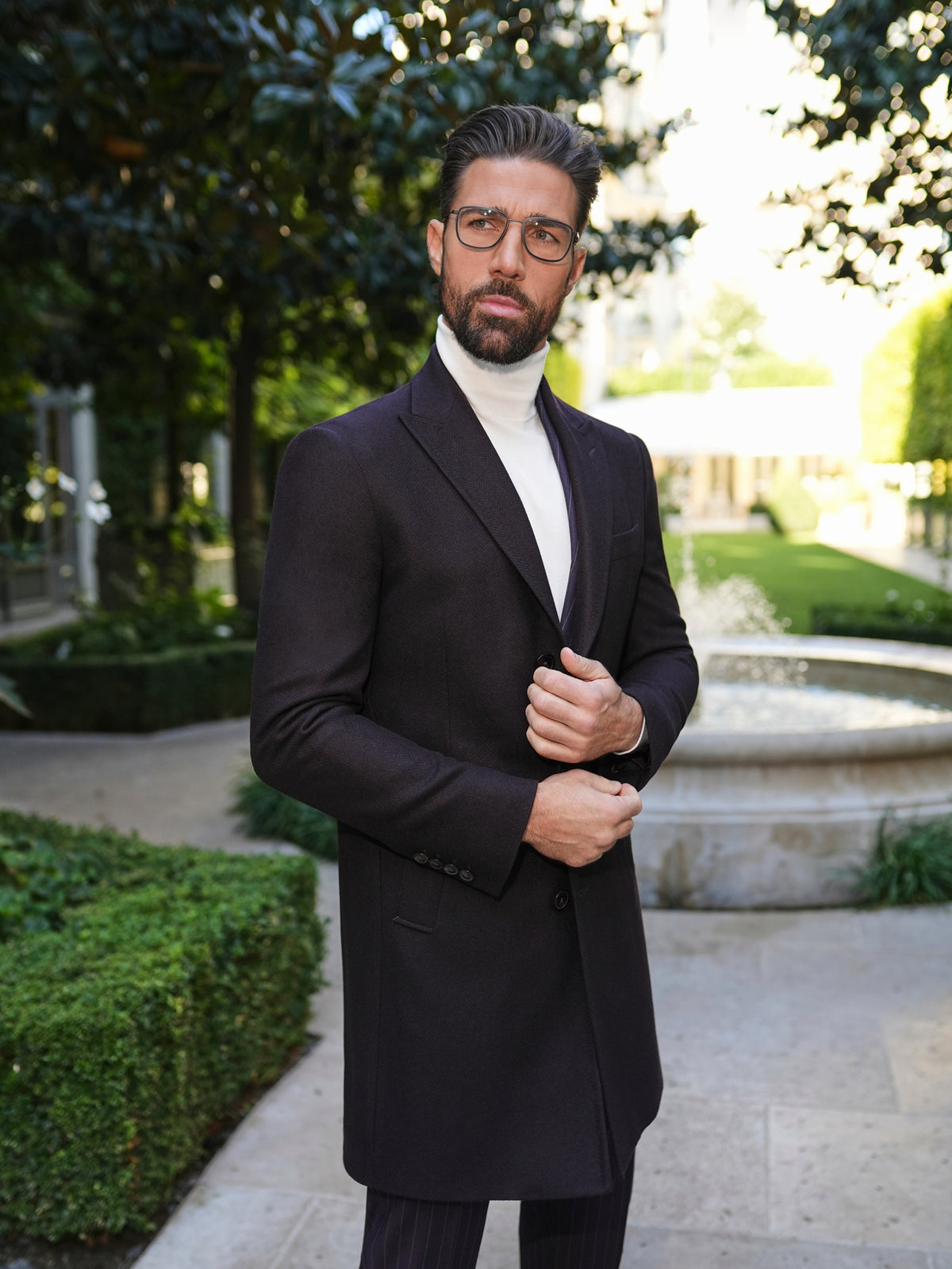Consiglieri St Moritz: dark overcoat with a white roll-neck and tonal trousers