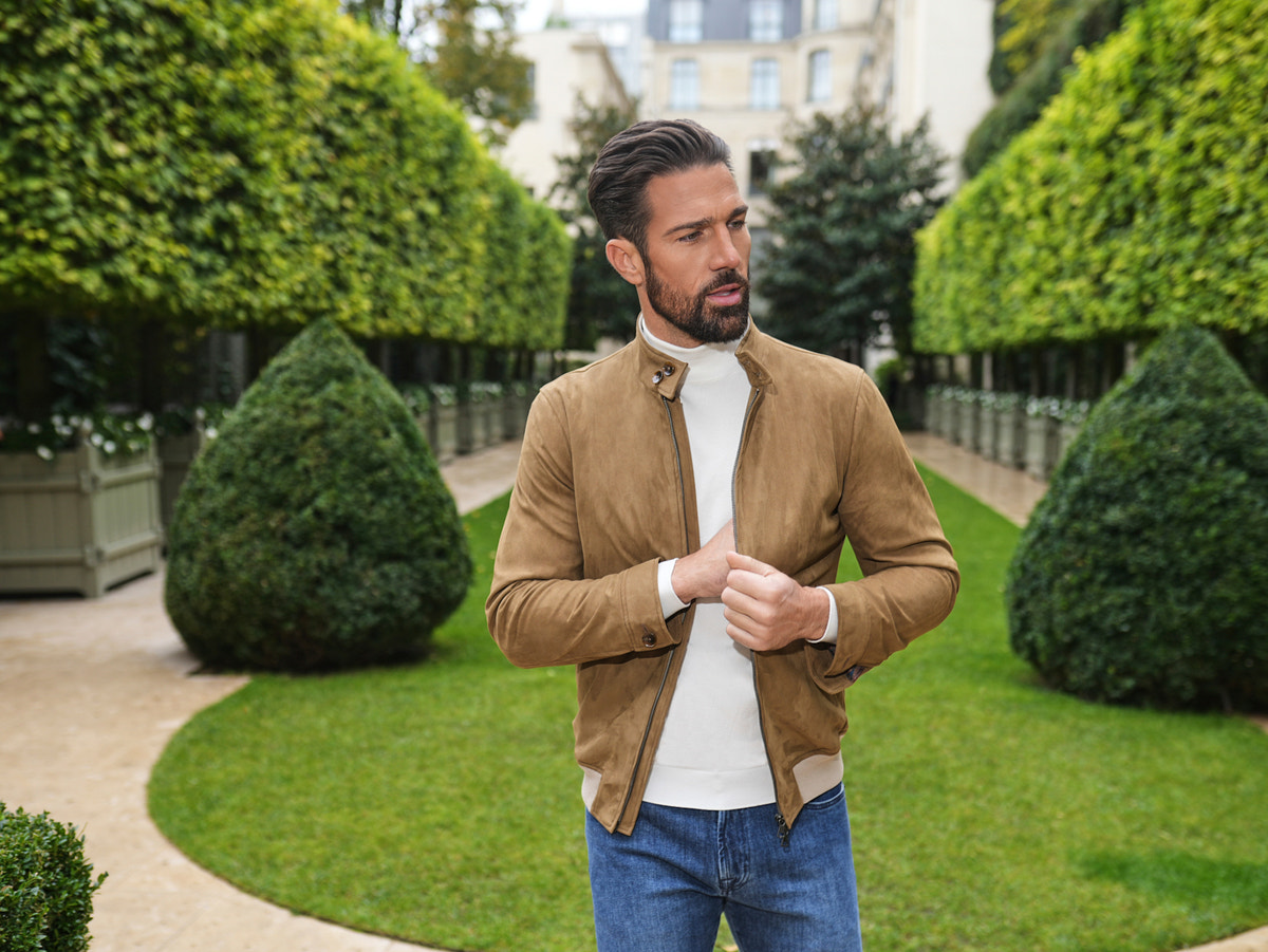 Consiglieri: ivory roll-neck beneath a light brown jacket
