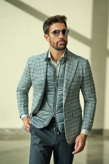 Consiglieri: grey zip-front gilet beneath a small-check jacket