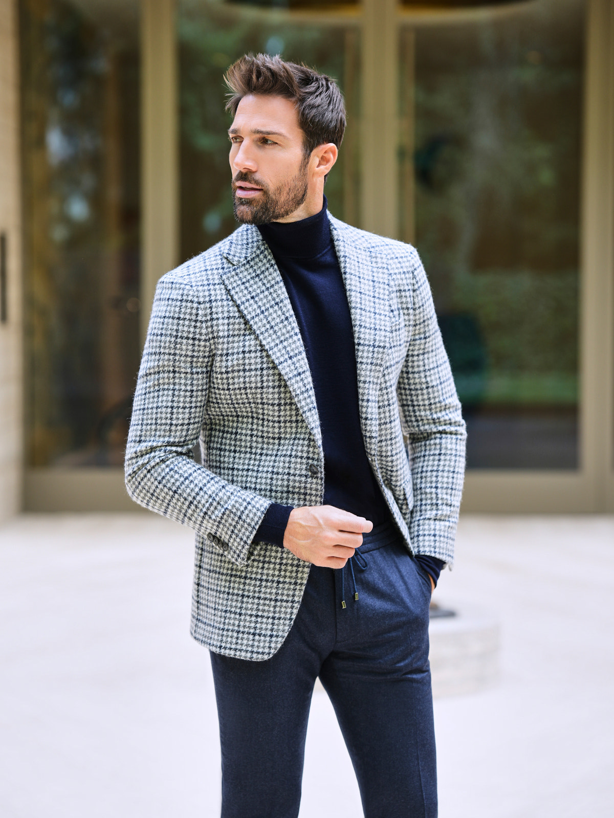Consiglieri: navy roll-neck beneath a light grey checked jacket