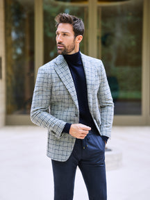 Consiglieri: navy roll-neck beneath a light grey checked jacket