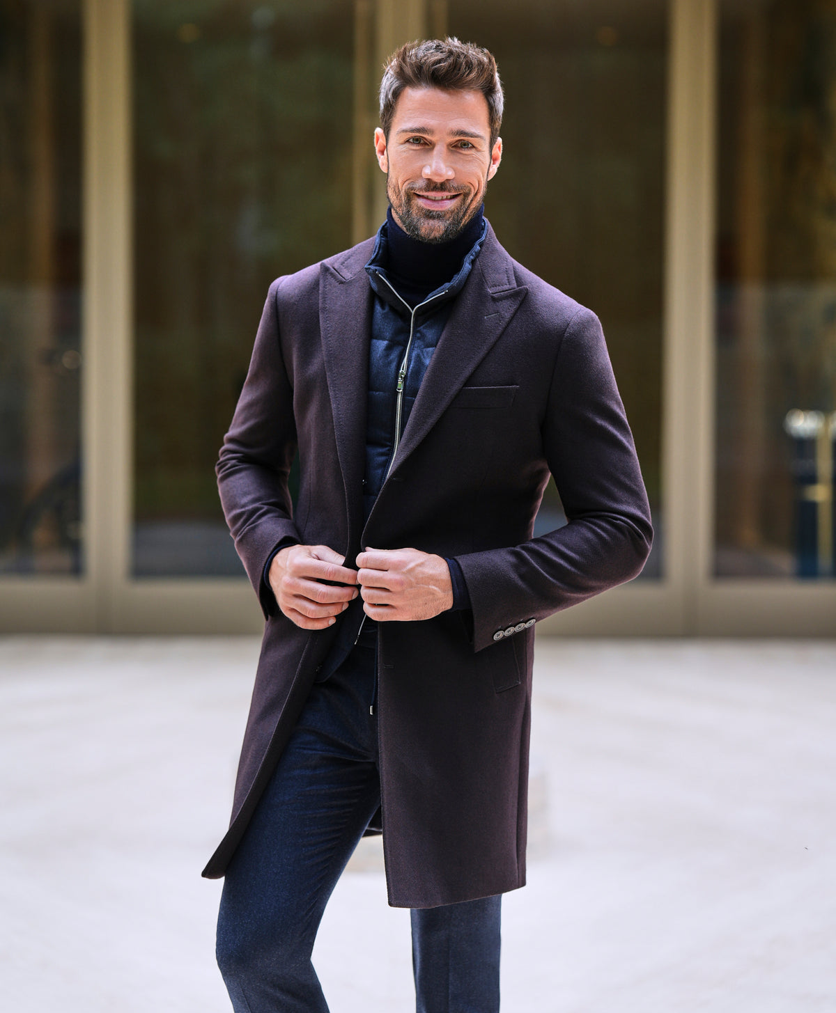 Consiglieri Davos: deep burgundy overcoat with a navy scarf and blue trousers