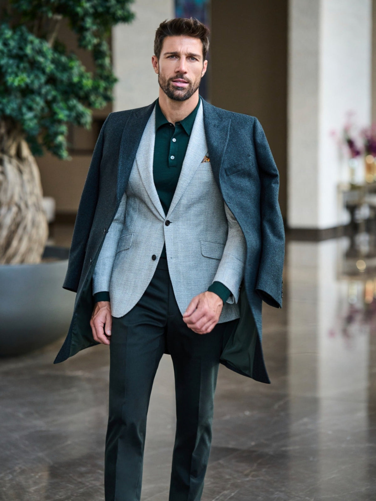 Consiglieri Val d'Isere: dark green overcoat draped over a light grey jacket