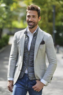 Consiglieri: grey quilted gilet styled with a light jacket and jeans