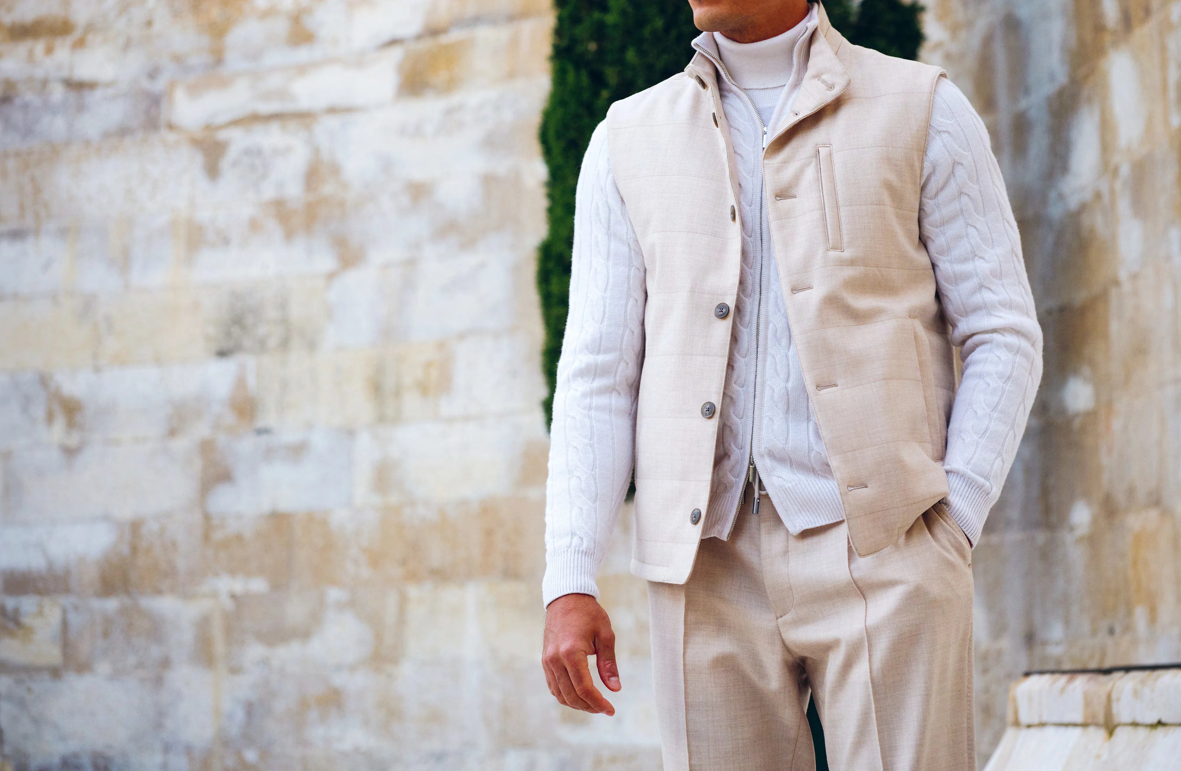 Ivory tonal outfit with layered knitwear and a vest