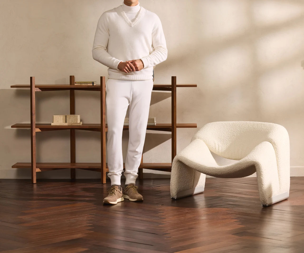 White high-neck knit with white trousers and taupe shoes