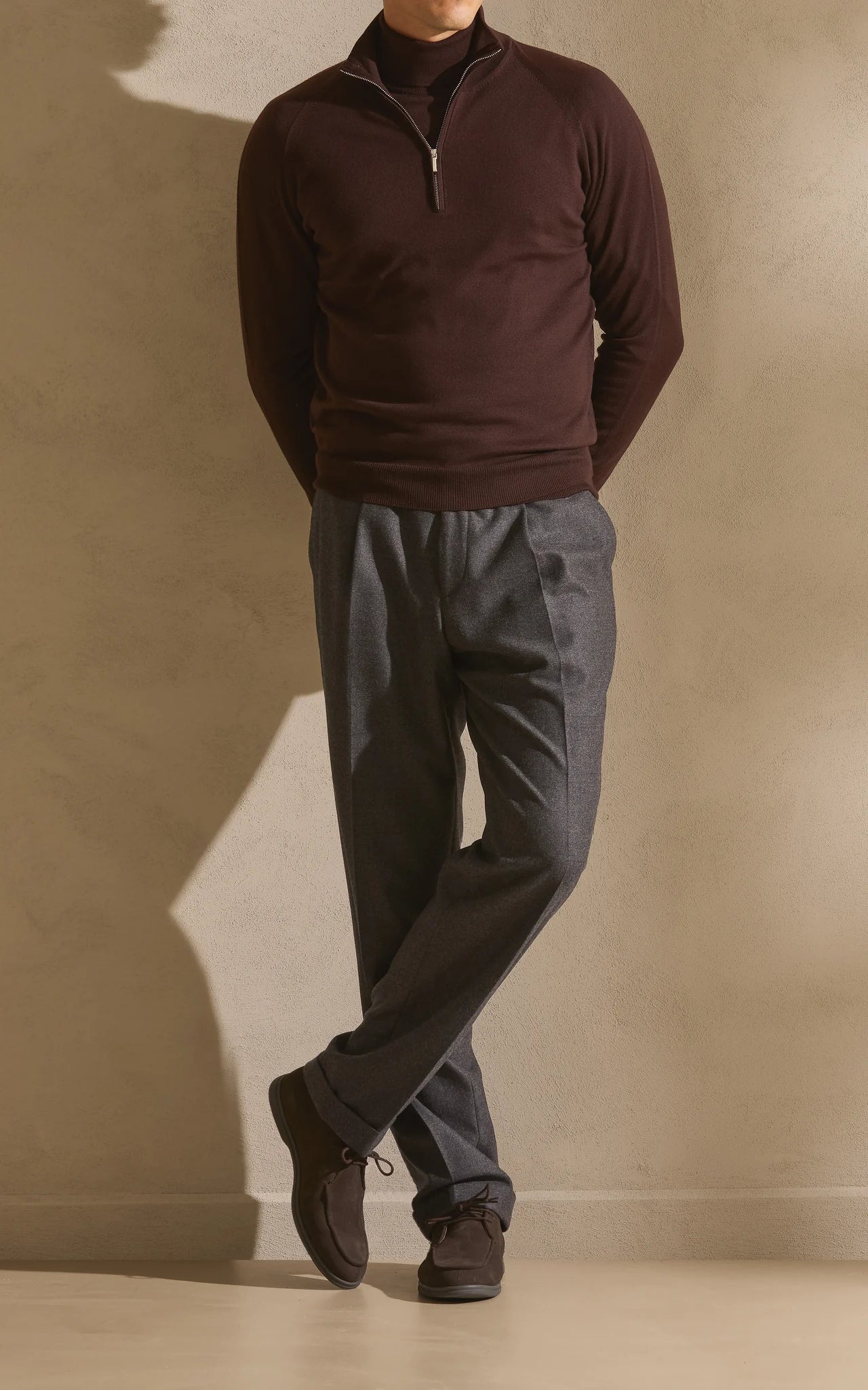 Half-zip knit worn with grey trousers and dark shoes