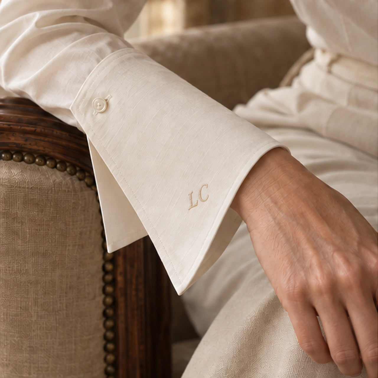 Close detail of the shaped ivory cuff and embroidered LC initials.