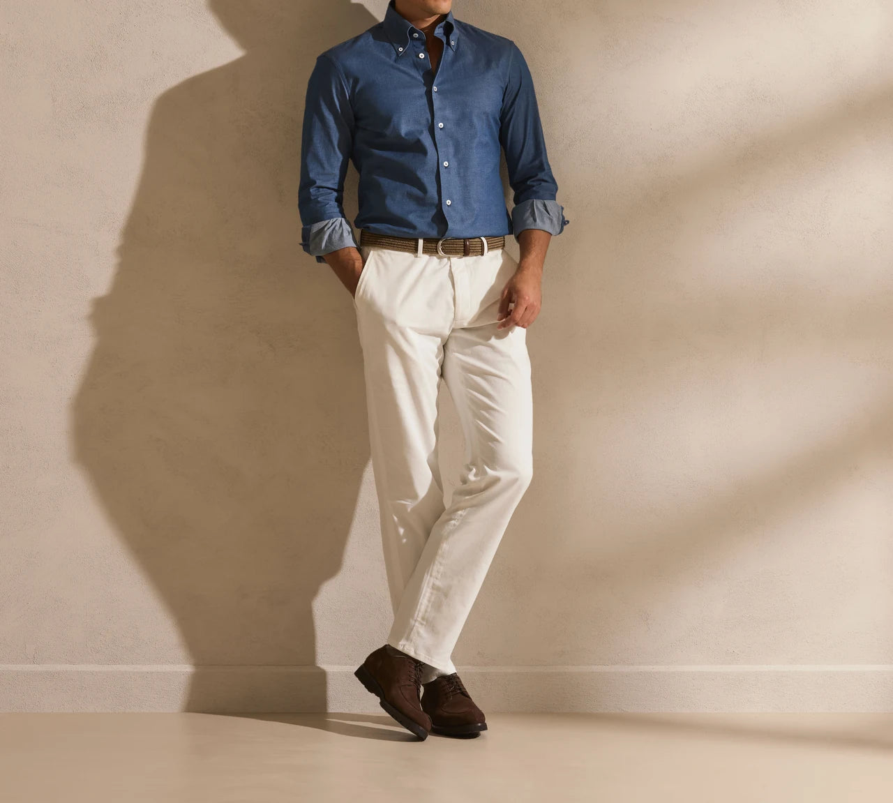 Blue shirt worn with light trousers