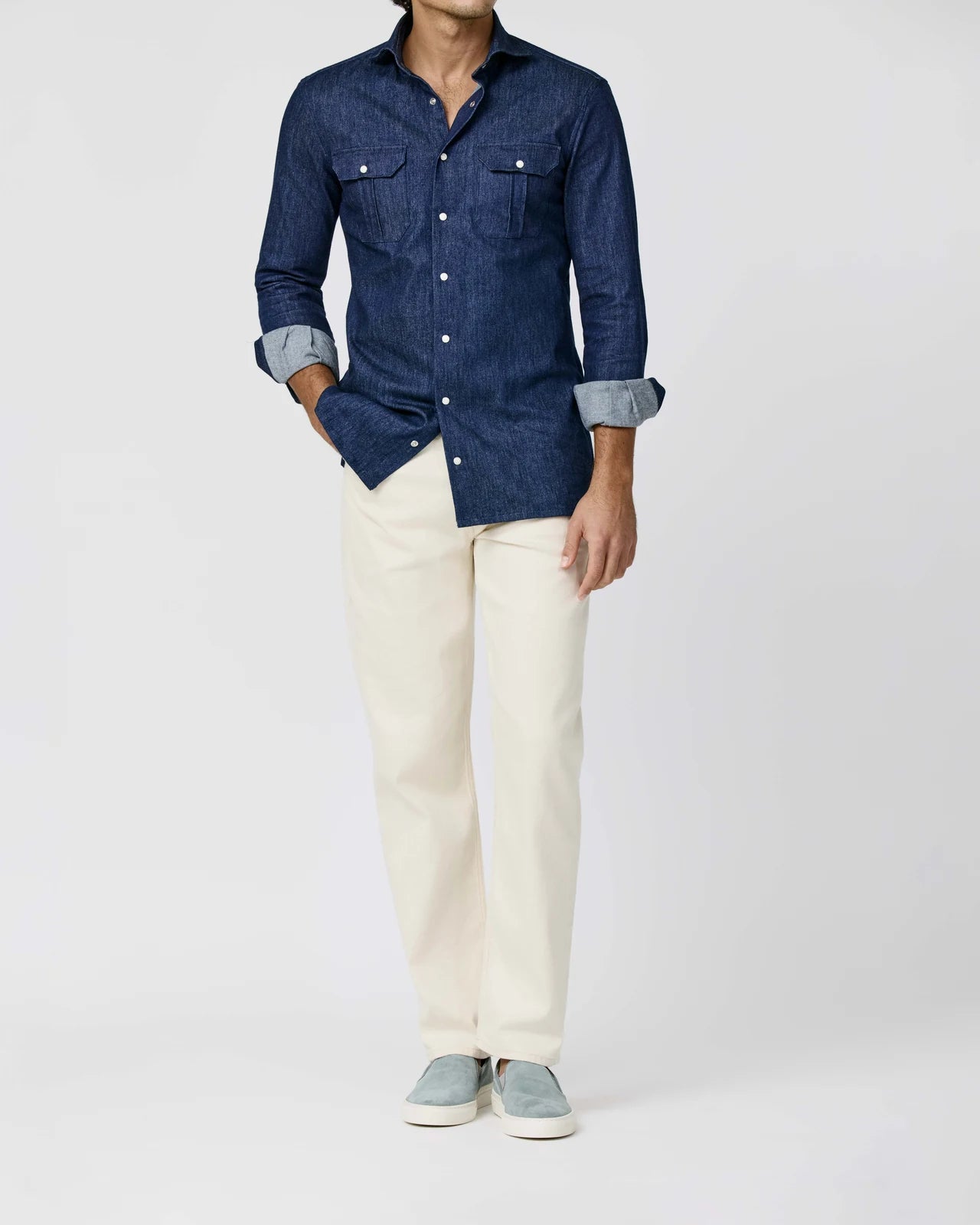 Navy shirt with chest pockets, worn with ivory trousers