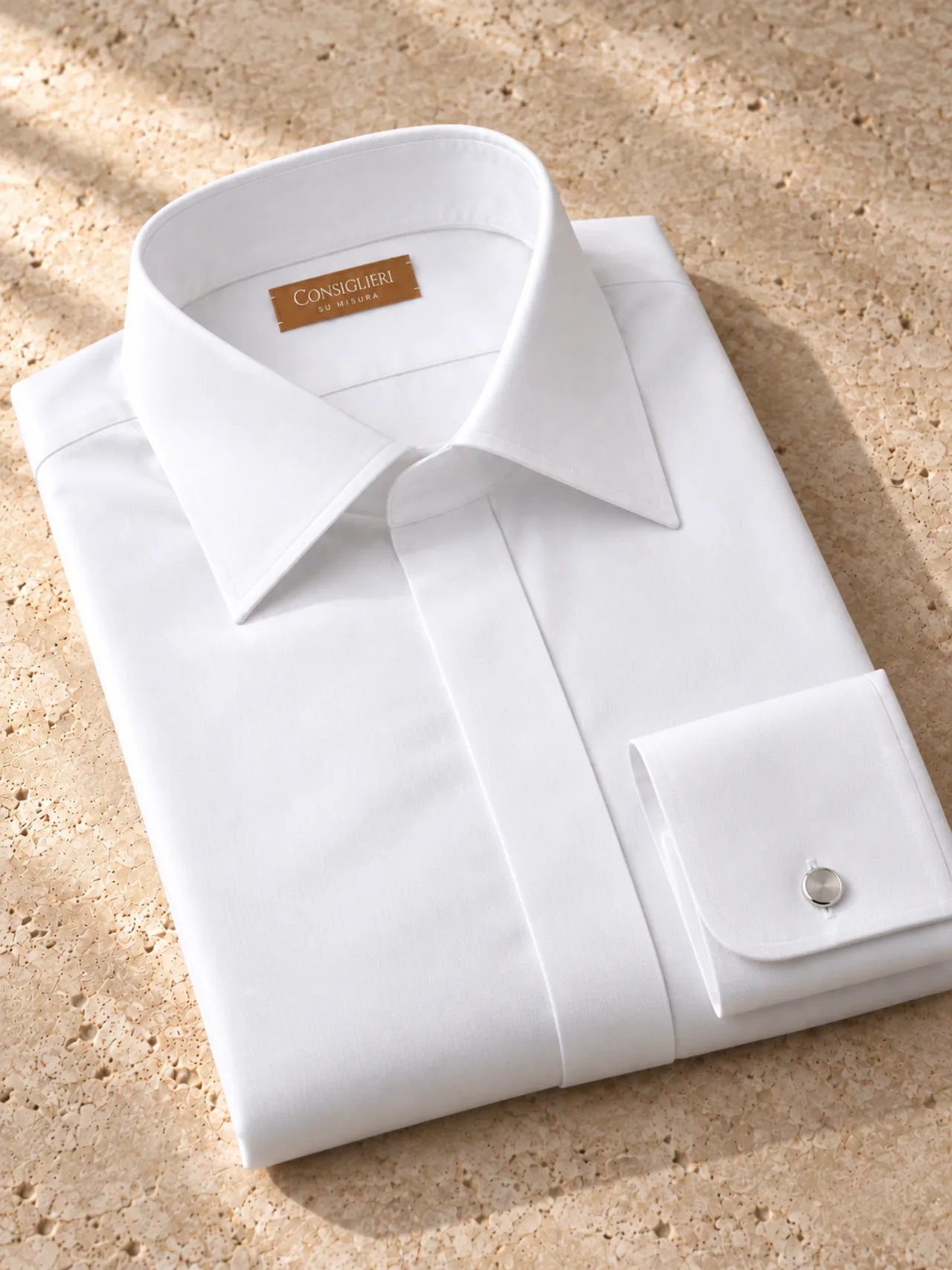 Folded evening white shirt, with the collar and cuff in view.