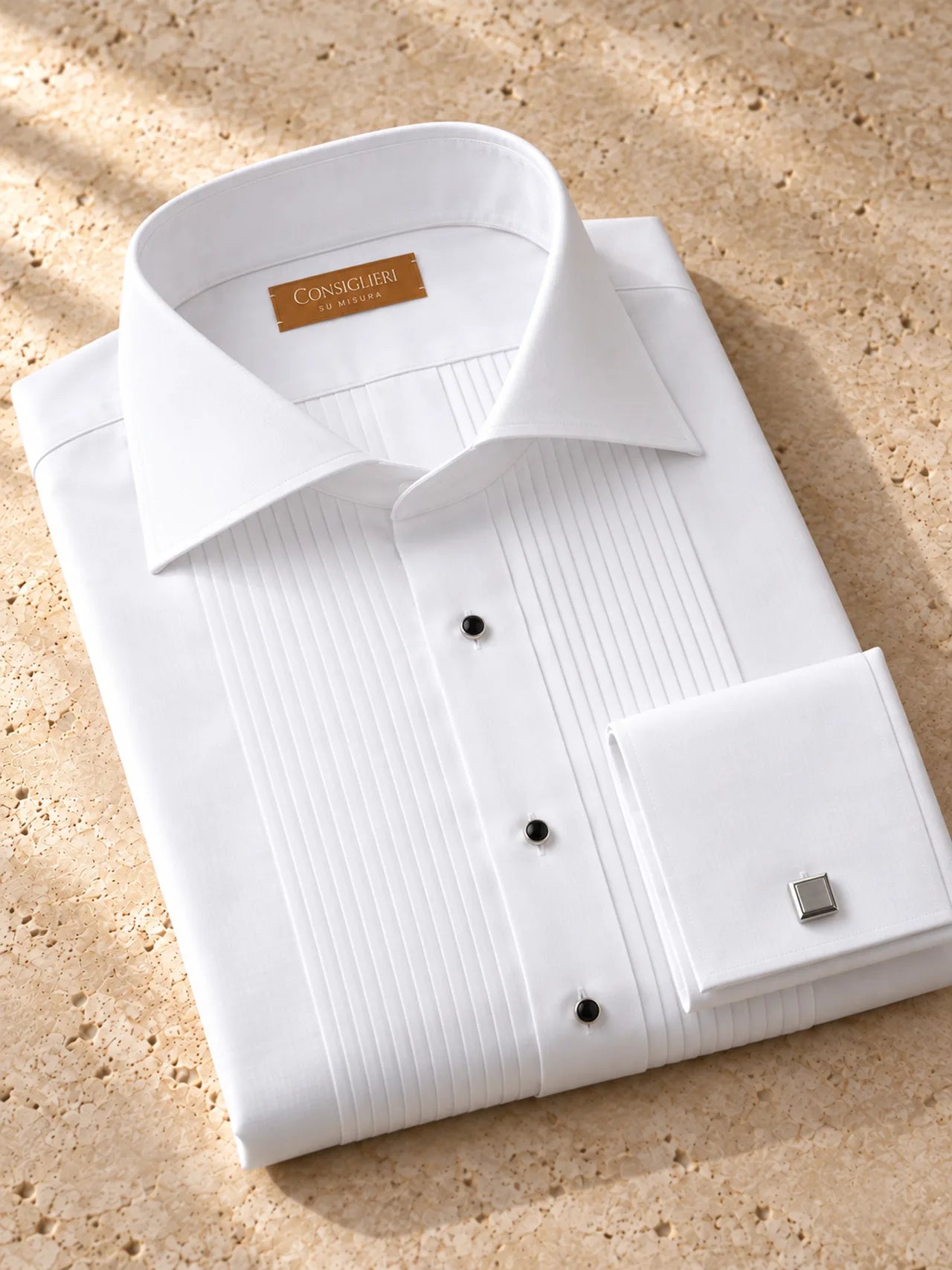Folded evening pleats shirt, with the collar and cuff in view.