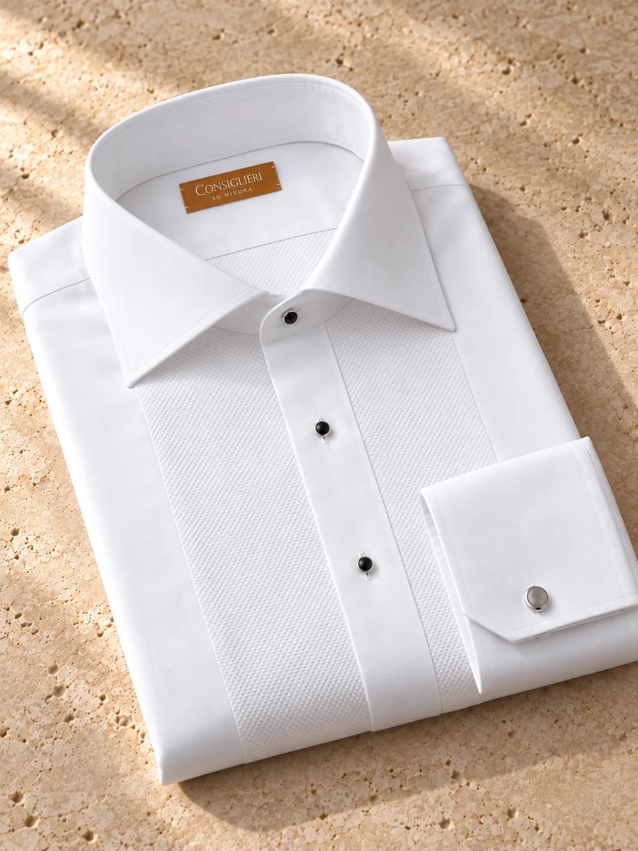 Folded evening piqué shirt, with the collar and cuff in view.