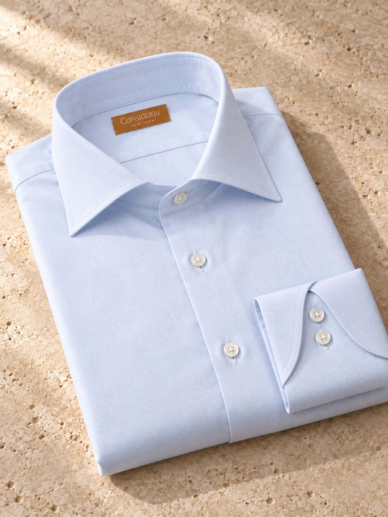 Folded neapolitan blue shirt, with the collar and cuff in view.